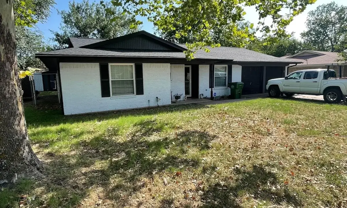 Professional roofing crew working on a residential roof in Bensville